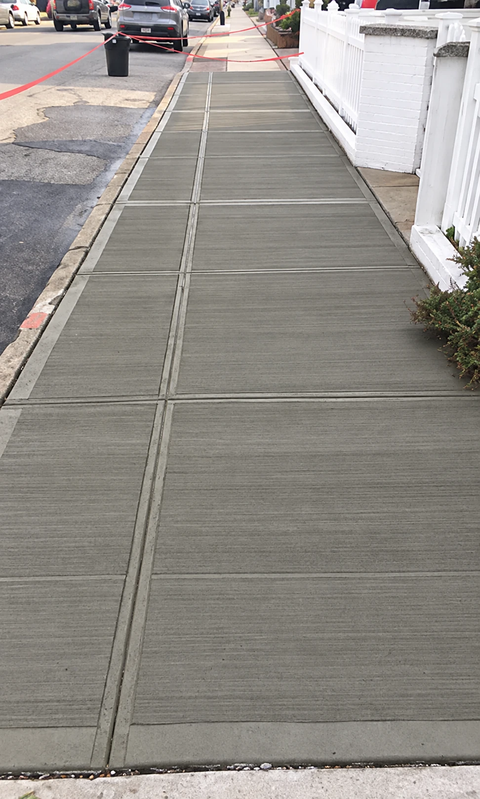 Concrete sidewalk with a textured finish and rectangular control joints