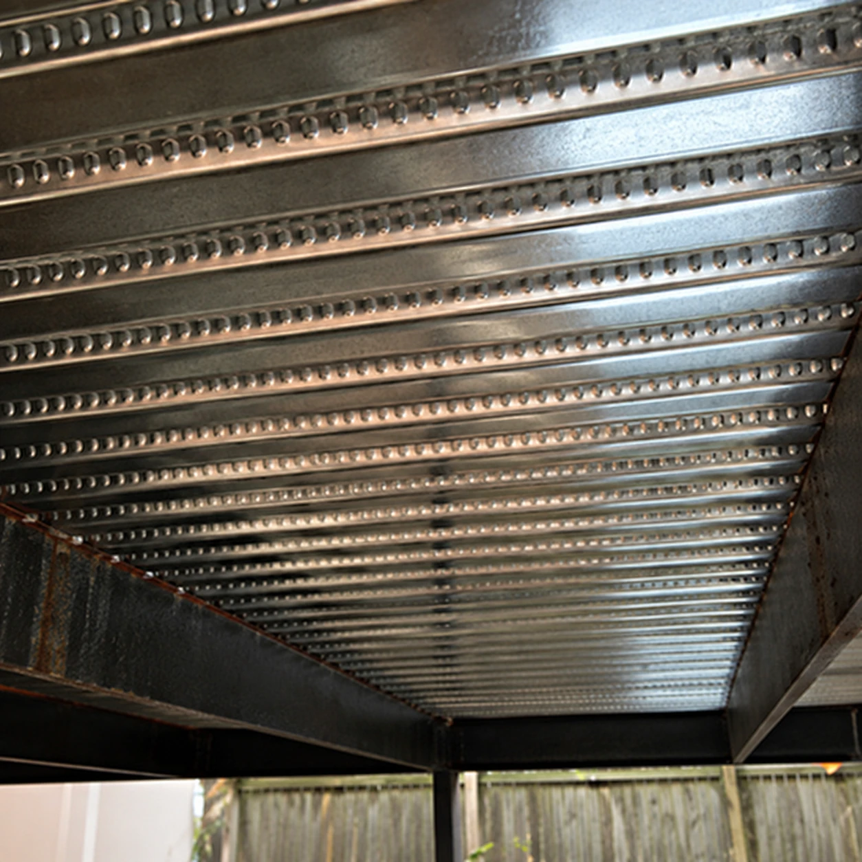 Underside of corrugated metal decking with steel support beams